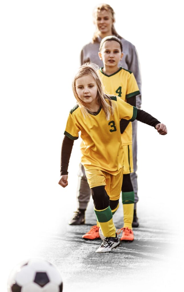 Two Youth Soccer Players Training, with Young Blonde Female Soccer Coach in the Background