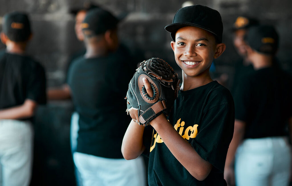 Young Boy Baseball Athlete in Uniform Smiling at Camera