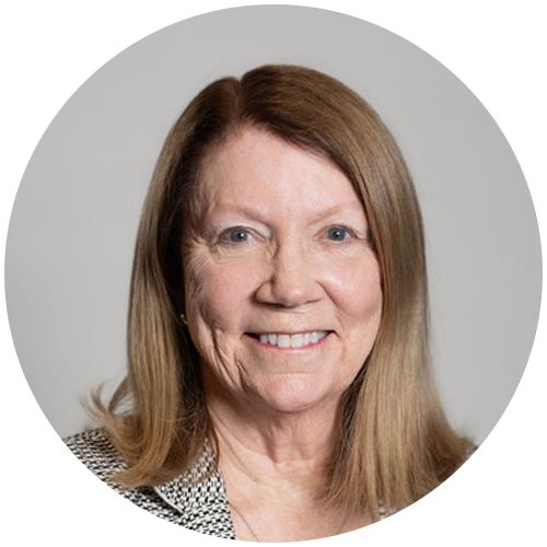 Lynn Nelson headshot on a gray background